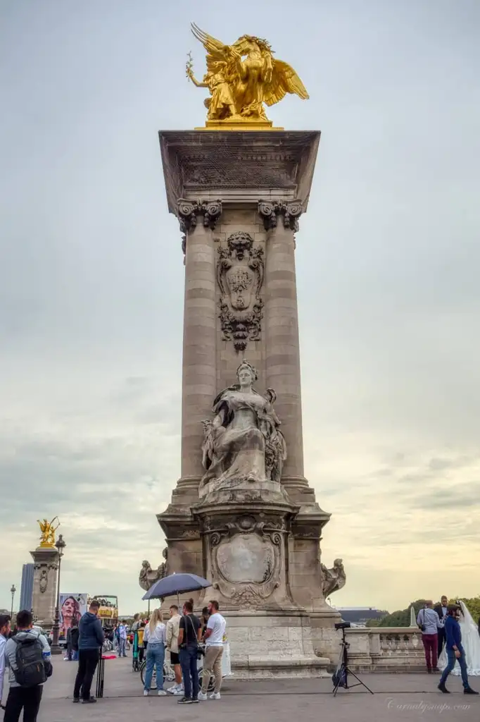 One of the Gilded Fames sculptures on the socle counterweights that help stabilize the Pont Alexandre III bridge
