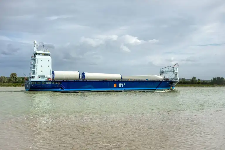 A barge carrying the huge parts of a wind farm floats along the Seine in Villequier