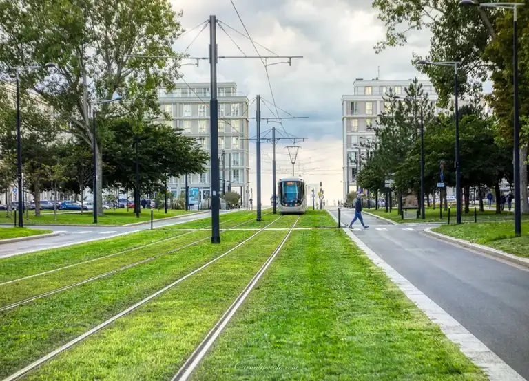  A Le Havre tram travels towards me with the Plage Le Havre (beach) in the distance