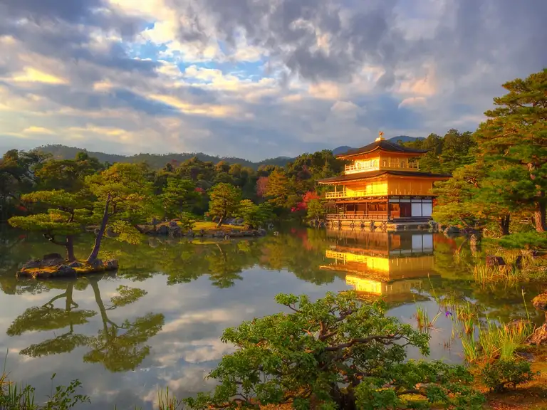 Golden Pavilion pond reflection with dramatic sky at Kinkaku ji Kyoto