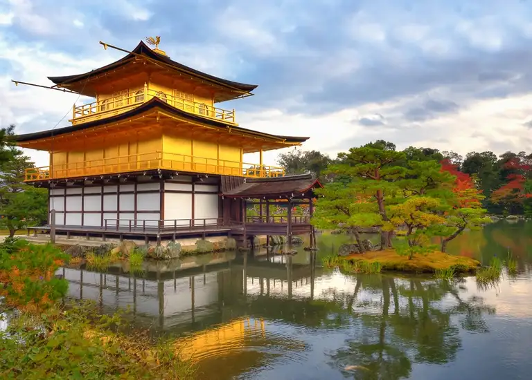 Back view of the Golden Pavilion with pond reflection and autumn colors at Kinkaku ji Kyoto