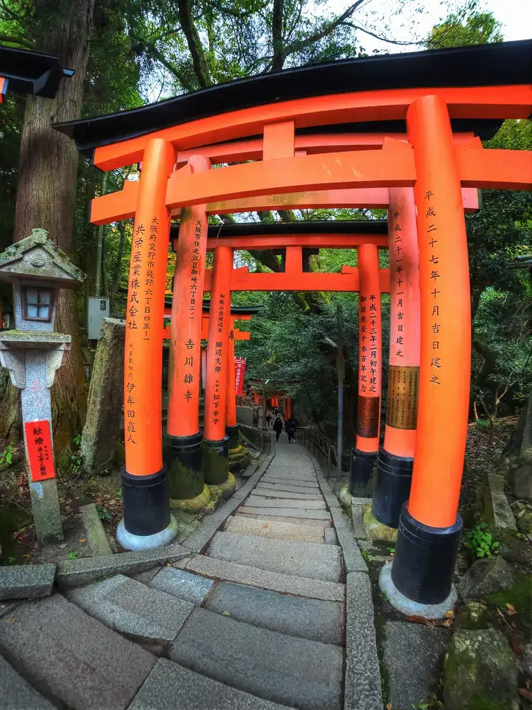 Traversing the steep steps of the woods and shrine in Fushimi Inari Taisha Kyoto