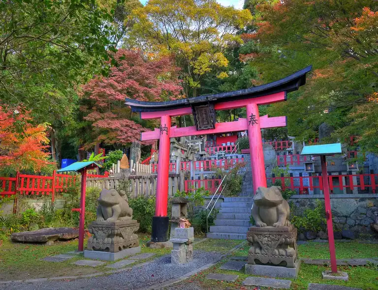 Torii gate and shrines with autumn colors at Fushimi Inari Taisha Kyoto