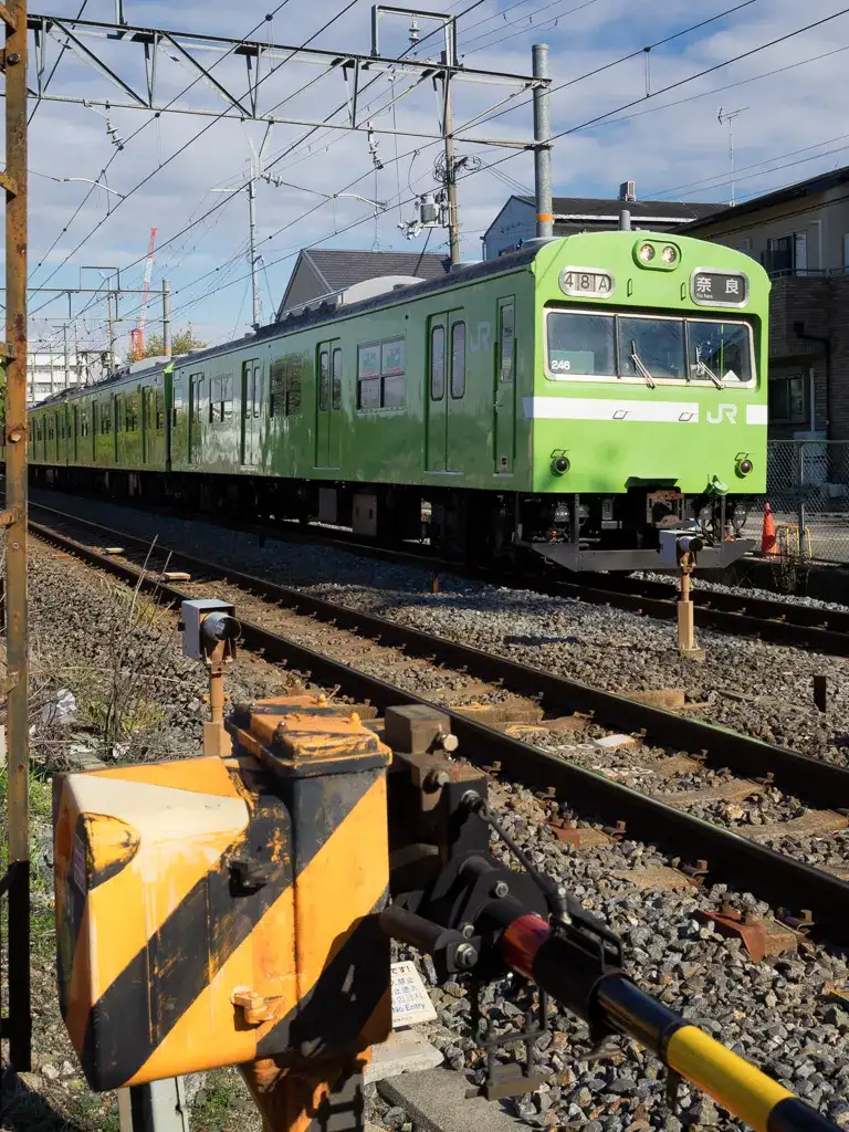 Train crossing with train to Nara passing by Kyoto