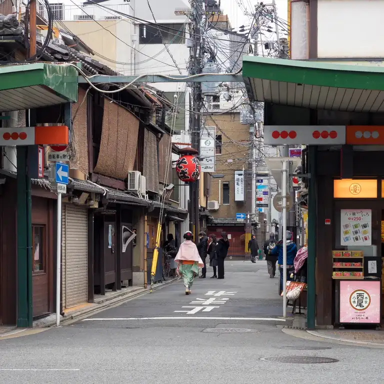 Geisha in the distance walking through a side street of Gion Kyoto