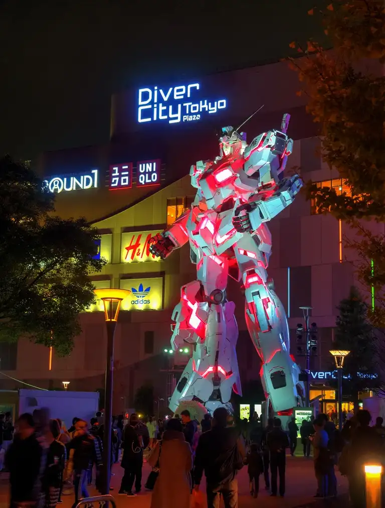  The Unicorn Gundam statue lit up at night outside Divercity Tokyo Plaza shopping mall Odaiba