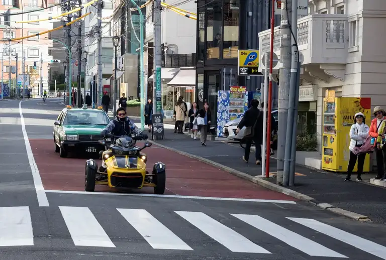 Three wheeled motorcross bike at a street crossing Harajuku