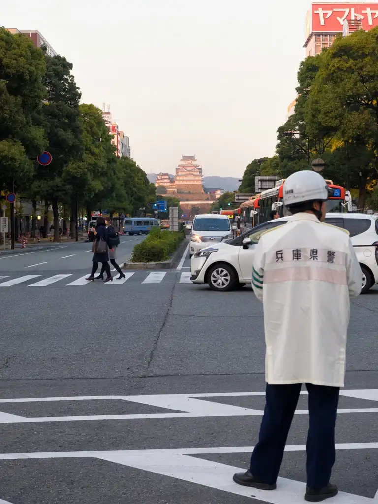 Traffic cop and Himeji Castle in the background Himeji