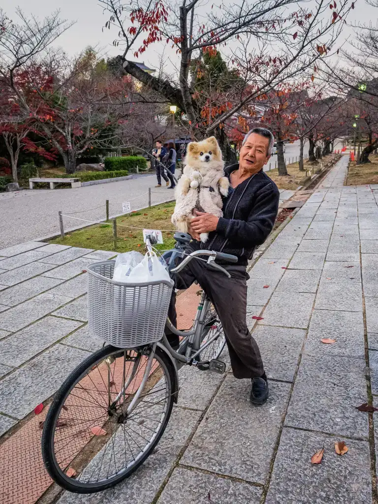 Japanese man posing with his bike companion his pet dog Himeji