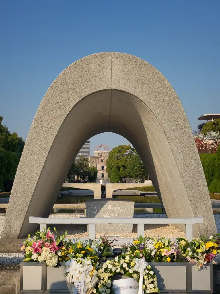 Cenotaph for the Atomic Bomb Victims with the A bomb Dome in the background Hiroshima Peace Memorial Park Hiroshima