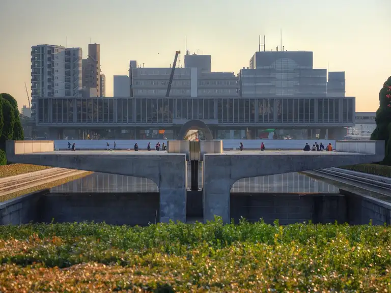 Cenotaph for the Atomic Bomb Victims with the main memorial building in the background Hiroshima Peace Memorial Park Hiroshima