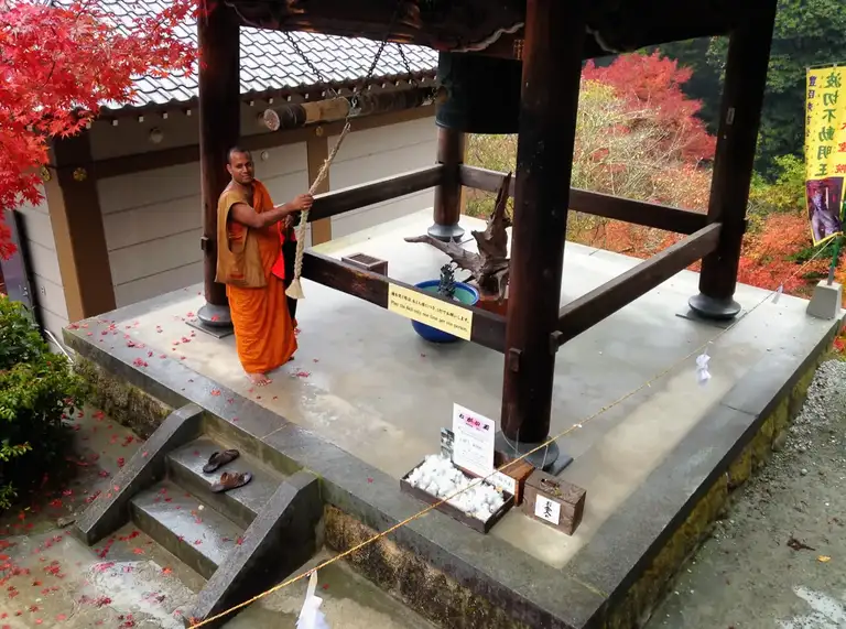 Buddhist monk ringing the Belfry Daisho in Temple Miyajima Island