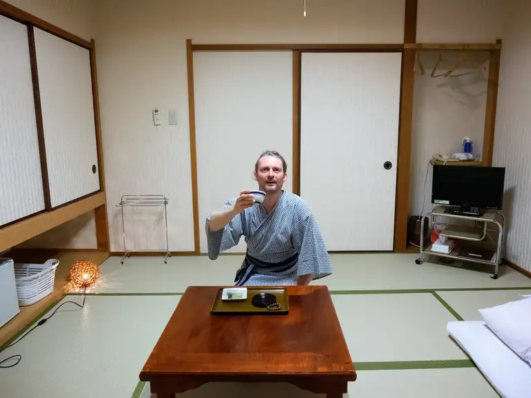 Yours truly having a cup of matcha green tea in my Yukata on the tatami floor of my Japanese style room at Sakuraya Inn Miyajima Island