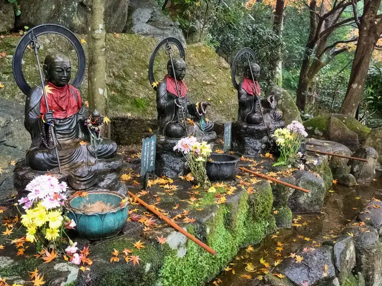  Three of the seven Jizo Bosatsu images to pour water on each one helps console the souls of lost babies and children Daisho in Temple Miyajima Island