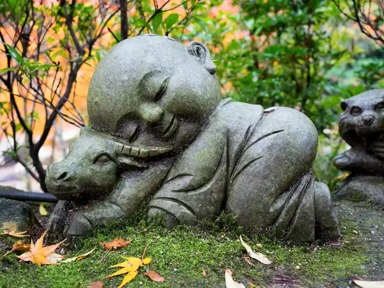 Jizo Bosatsu sleeping on a cow Daisho in Temple Miyajima Island