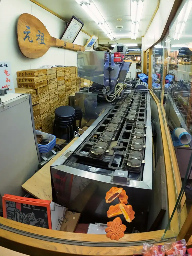 Machine that churns out Momiji Manju and a pretty large rice scoop on the wall Miyajima Island