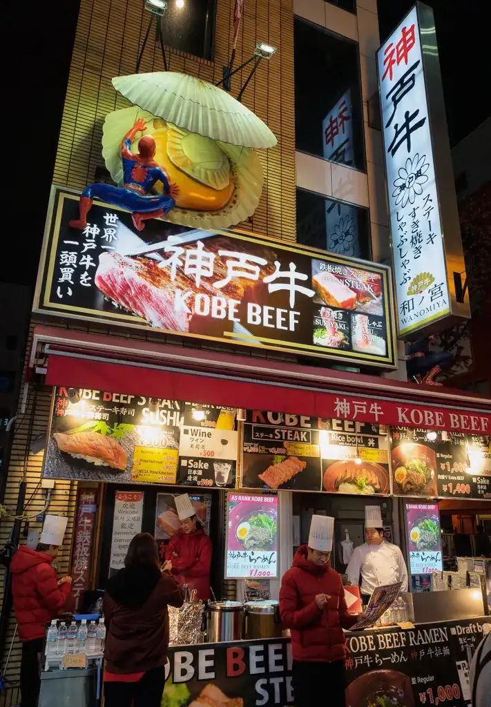 Spiderman climbing into a clam above a Kobe Beef restaurant in Dotombori Osaka Night time