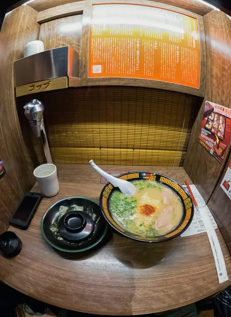 Ichiran Ramen booth where your waiter appears from under the bamboo blind if you need anything Dotombori Osaka Night time